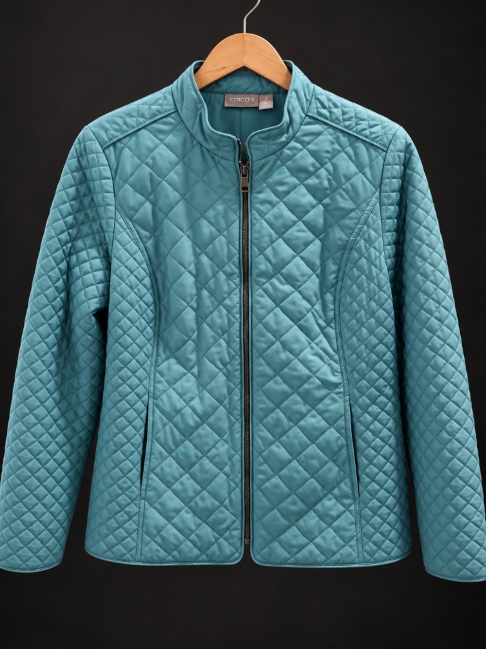 Chico’s light blue, full zip quilted jacket.